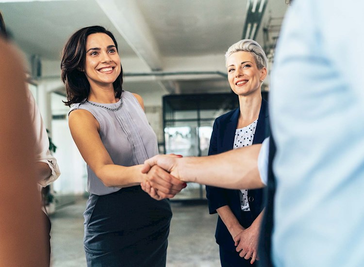 A group of people shaking hands in the office